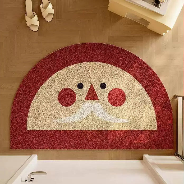 Decorative doormat with a Santa face design, placed on a wooden floor.